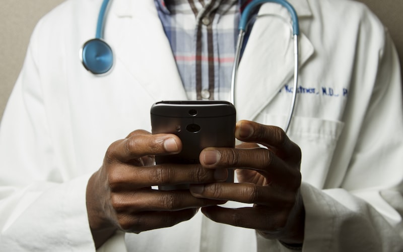 Doctor using clinical chat on mobile device